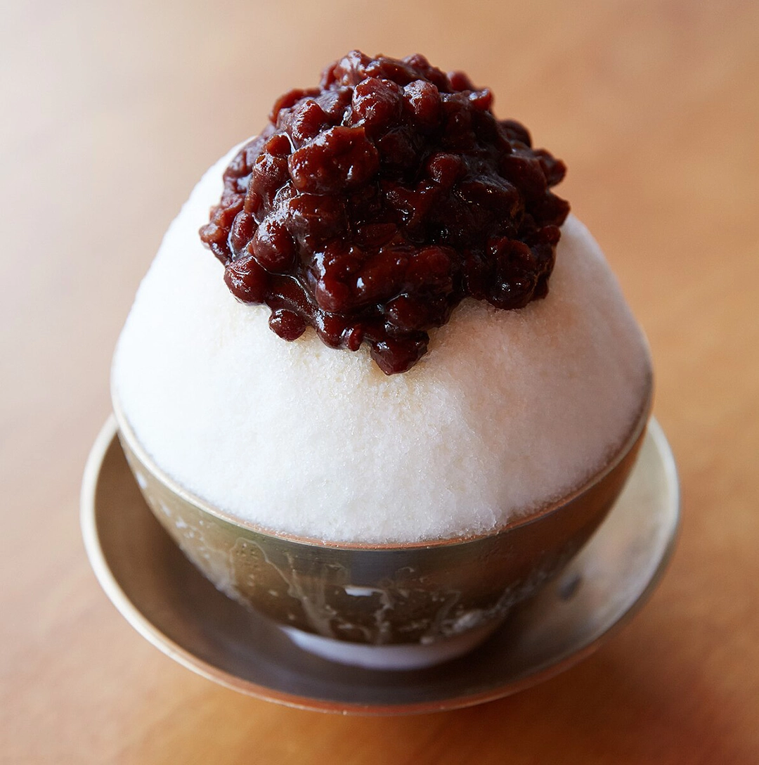 A small bowl of patbingsu with red bean on the top